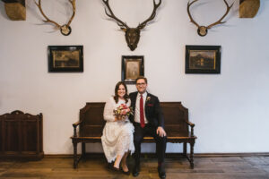 Brautpaar sitzt im Rathaus Schliersee auf einer Bank