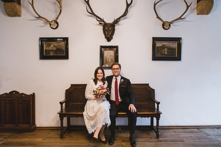 Brautpaar sitzt im Rathaus Schliersee auf einer Bank